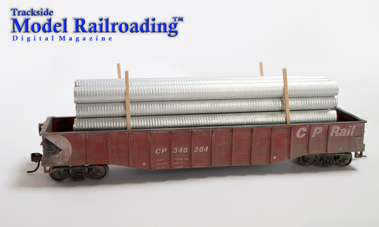 HO scale gondola train car as it is being loaded with the corrugated galvanized pipes from this months how to project in Trackside Model Railroading digital magazine.